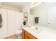 Bright bathroom featuring a large mirror, white cabinets, and neutral color scheme at 8510 Glade Ct, Huntersville, NC 28078