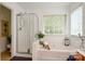 Bright bathroom featuring a soaking tub, a separate shower, and modern fixtures at 8510 Glade Ct, Huntersville, NC 28078