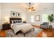 Relaxing bedroom showcasing hardwood floors, a ceiling fan, and ample natural light at 8510 Glade Ct, Huntersville, NC 28078