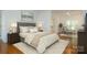 Cozy bedroom featuring stylish furnishings, hardwood floors, and serene decor at 8510 Glade Ct, Huntersville, NC 28078