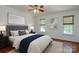 Comfortable bedroom with a plush bed, soft lighting, and large windows with wooded views at 8510 Glade Ct, Huntersville, NC 28078