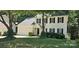 Charming two-story home with a well-maintained lawn, attached two car garage, and mature trees at 8510 Glade Ct, Huntersville, NC 28078