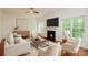 Bright and airy living room with a fireplace, large windows, and a ceiling fan at 8510 Glade Ct, Huntersville, NC 28078