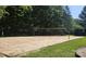 Sandy community volleyball court nestled among lush greenery for outdoor fun at 8510 Glade Ct, Huntersville, NC 28078