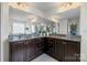 Luxurious bathroom with granite countertops, dual sinks, and vanity mirrors at 958 Skywater Dr, Fort Mill, SC 29715