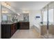 Main bathroom with dual sinks, granite countertops, soaking tub, and glass shower at 958 Skywater Dr, Fort Mill, SC 29715