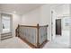 Upstairs hallway with wood and wrought iron railing provides access to the upper level at 958 Skywater Dr, Fort Mill, SC 29715