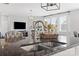 Modern kitchen features granite countertops, stainless steel sink, and opens to the living area at 958 Skywater Dr, Fort Mill, SC 29715