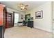 Bedroom features a dark-wood bookshelf, modern computer desk and chair at 9600 Lockhorn Ct, Mint Hill, NC 28227