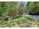 Charming brick home featuring a two-car garage and a well-manicured lawn with mature trees at 9600 Lockhorn Ct, Mint Hill, NC 28227
