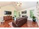 Inviting living room with hardwood floors, vaulted ceiling, fireplace, and modern decor at 9600 Lockhorn Ct, Mint Hill, NC 28227