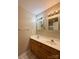 Bathroom featuring double sink vanity with storage, large mirrors, and updated lighting fixtures at 9730 Elizabeth Townes Ln, Charlotte, NC 28277