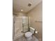Bathroom featuring a shower stall with sliding glass door, a toilet, and neutral tiled floors at 9730 Elizabeth Townes Ln, Charlotte, NC 28277