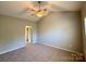 Spacious bedroom featuring a ceiling fan, neutral walls and carpeted floors, providing comfort and style at 9730 Elizabeth Townes Ln, Charlotte, NC 28277