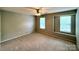 Bedroom featuring neutral carpet, walls, and two windows for natural light at 9730 Elizabeth Townes Ln, Charlotte, NC 28277
