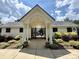 Clubhouse entrance with an arched portico, black gated fence, and landscaped front yard at 9730 Elizabeth Townes Ln, Charlotte, NC 28277