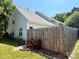 Exterior view of home with fenced yard and grassy lawn at 9730 Elizabeth Townes Ln, Charlotte, NC 28277
