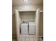 The laundry closet has open doors revealing the washer and dryer, with shelving above at 9730 Elizabeth Townes Ln, Charlotte, NC 28277