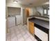 Convenient laundry area with a washer, dryer, and tiled floors, easily accessible from the kitchen at 9730 Elizabeth Townes Ln, Charlotte, NC 28277