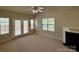 Spacious living room with a fireplace, carpet, and lots of natural light, creating a cozy atmosphere at 9730 Elizabeth Townes Ln, Charlotte, NC 28277