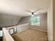 Inviting loft space with natural light, a ceiling fan and carpeted floors, perfect for flexible living at 9730 Elizabeth Townes Ln, Charlotte, NC 28277