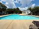 Community pool with a diving area, lounge chairs, and a nearby building at 9730 Elizabeth Townes Ln, Charlotte, NC 28277