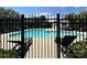 Community pool area with lounge chairs, accessed through a secure black fence at 9730 Elizabeth Townes Ln, Charlotte, NC 28277