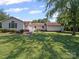 View of home with a large backyard featuring lush green grass and mature trees at 1302 Hawthorne Rd, Lancaster, SC 29720