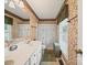 Bathroom features patterned wallpaper, white vanity with sink, toilet, and shower/tub combination at 1302 Hawthorne Rd, Lancaster, SC 29720