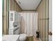 Cozy bathroom featuring a toilet with built-in shelving and a shower with a white curtain at 1302 Hawthorne Rd, Lancaster, SC 29720