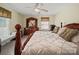 Comfortable bedroom with plush bedding, wooden furniture, and a ceiling fan for a cozy atmosphere at 1302 Hawthorne Rd, Lancaster, SC 29720