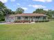 Charming single-story home with a welcoming front porch, landscaped yard, and attached two-car garage at 1302 Hawthorne Rd, Lancaster, SC 29720