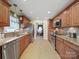 Well-equipped kitchen with stainless steel appliances, tile floor and wooden cabinets at 1302 Hawthorne Rd, Lancaster, SC 29720