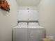 Functional laundry room with white washer and dryer and storage cabinets above at 1302 Hawthorne Rd, Lancaster, SC 29720