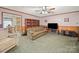 Cozy living room with classic wallpaper and wood paneling, flowing into a dining area at 1302 Hawthorne Rd, Lancaster, SC 29720
