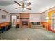 Warm living room with brick fireplace, wood trim, and ceiling fan at 1302 Hawthorne Rd, Lancaster, SC 29720
