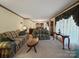 Spacious living room with patterned sofas, coffee table, and decoratively draped windows at 1302 Hawthorne Rd, Lancaster, SC 29720