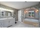 Bright bathroom features a tub by the window and vanity with mirror, offering relaxation and functionality at 135 Primrose Dr, Salisbury, NC 28147