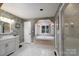 Bathroom features a soaking tub, white cabinets, and tiled floors at 135 Primrose Dr, Salisbury, NC 28147