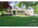 Charming two-story home featuring a landscaped front yard, white porch, and two-car garage at 135 Primrose Dr, Salisbury, NC 28147