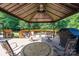 Covered gazebo with furniture and grill, overlooking green backyard at 135 Primrose Dr, Salisbury, NC 28147