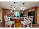 Well-lit kitchen featuring wood cabinets, island with barstool seating, and modern appliances at 135 Primrose Dr, Salisbury, NC 28147