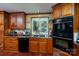 Kitchen showcases wooden cabinets, sleek black appliances, and a window over the sink at 135 Primrose Dr, Salisbury, NC 28147