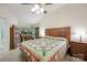 Spacious bedroom with a large bed, wood furniture, and a well-lit sitting area by the windows at 140 Quiet Cove Rd, Mooresville, NC 28117