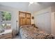 Serene bedroom featuring a quilt, decorative wooden doors, a window, and a closet at 140 Quiet Cove Rd, Mooresville, NC 28117