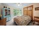 Inviting bedroom with a colorful quilt, turquoise accent cabinet, a large window, and cozy ambiance at 140 Quiet Cove Rd, Mooresville, NC 28117
