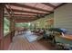 Expansive covered deck with seating, dining area, and wooded views, perfect for outdoor entertaining at 140 Quiet Cove Rd, Mooresville, NC 28117