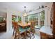 Cozy dining area featuring a square wood table, cushioned chairs, and a bay window with garden views at 140 Quiet Cove Rd, Mooresville, NC 28117