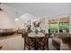 Open concept living and dining area, featuring a fireplace, comfortable seating, and backyard view at 140 Quiet Cove Rd, Mooresville, NC 28117