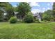 Gray home with lush green lawn and trees, offering a private and serene setting at 140 Quiet Cove Rd, Mooresville, NC 28117